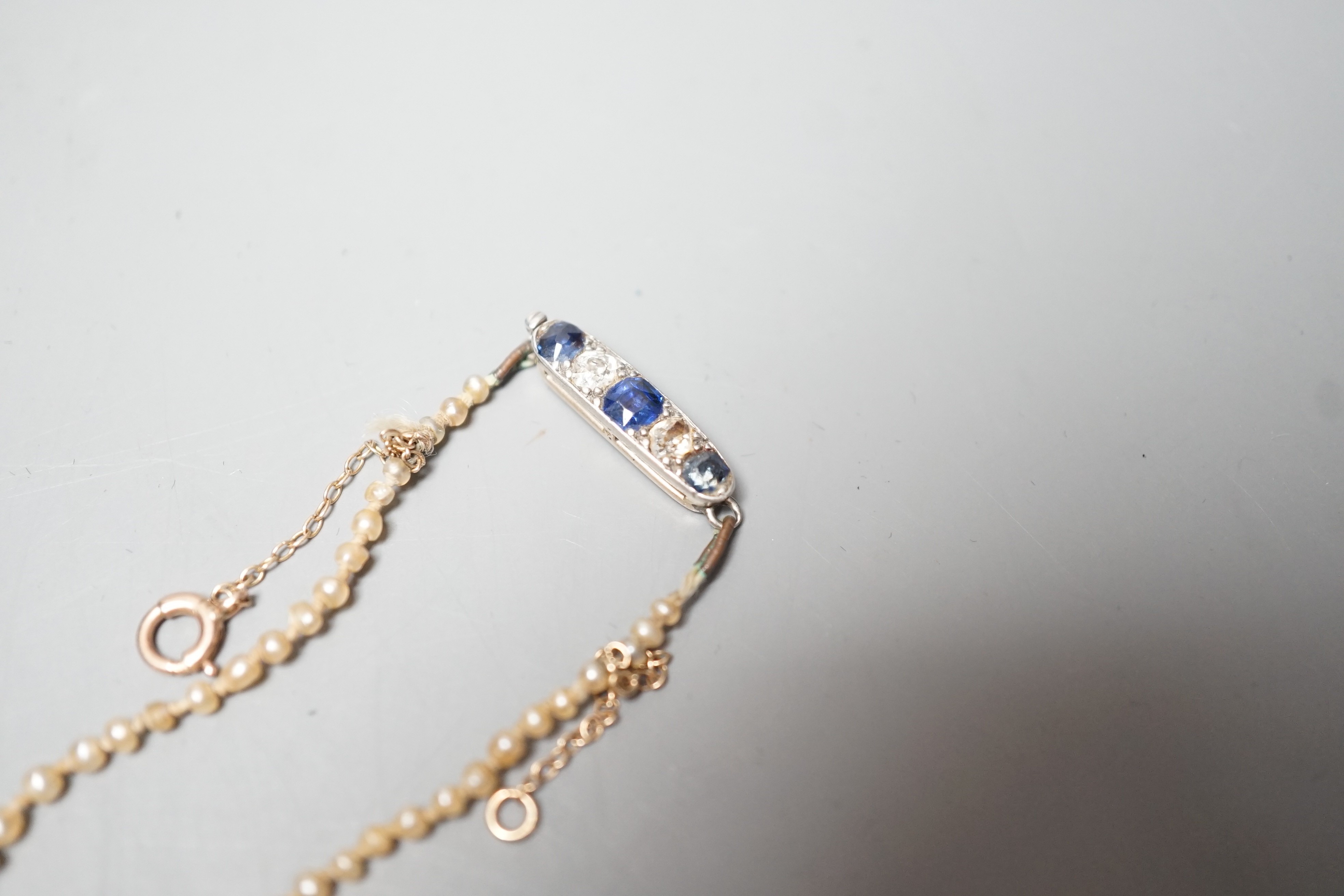 A single strand graduated natural saltwater pearl necklace, with sapphire and diamond set clasp, 44cm, gross weight 7 grams, with accompanying GCS report dated 23/11/2022.